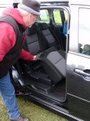 Mazda representative reveals the Mazda5's hidden underseat storage feature. Photo by Bill Roebuck.